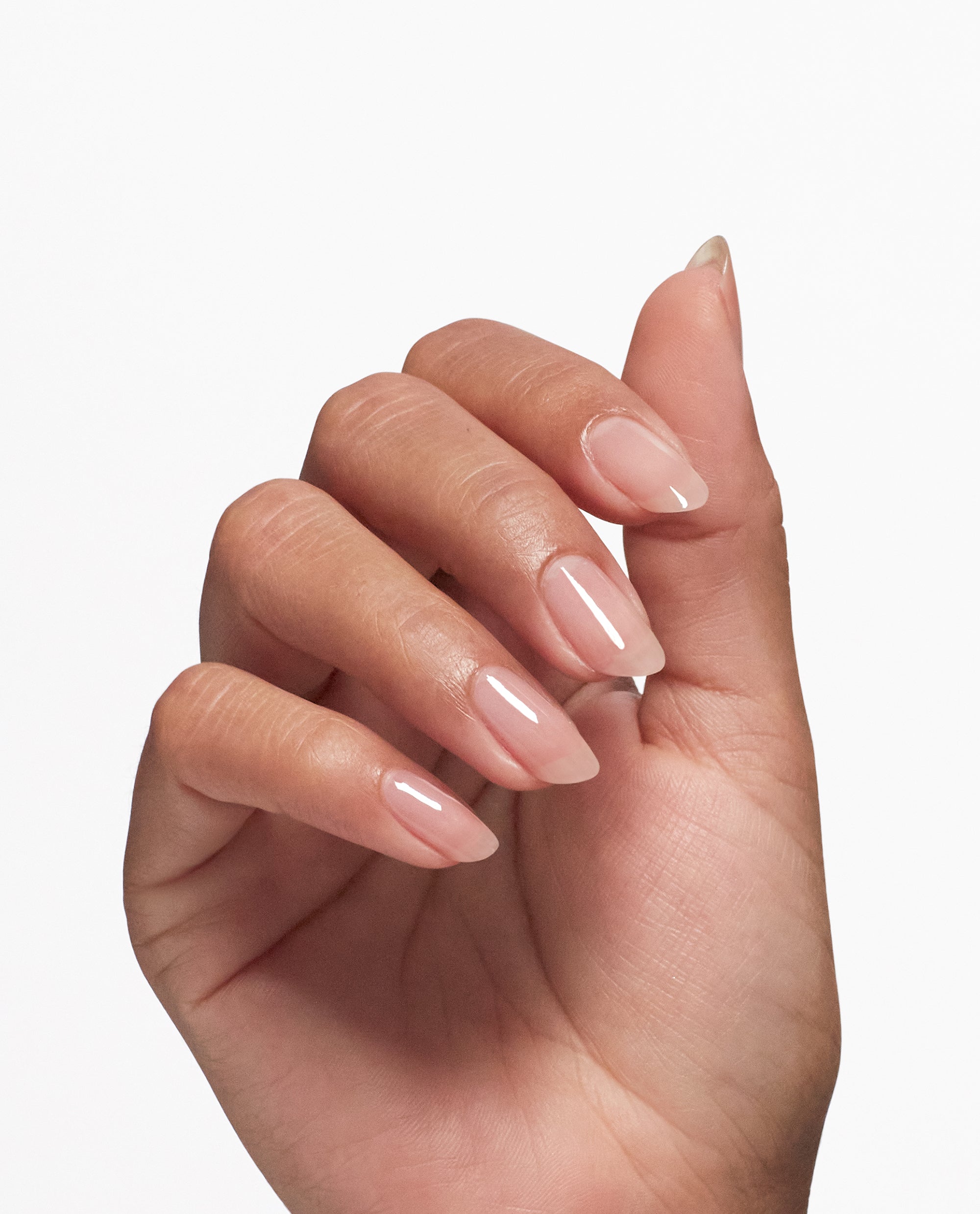 Hand with long, natural-looking nails coated in a glossy sheer pink finish, showing the strengthening results of Nail Envy® Pink To Envy Nail Strengthener by OPI, ideal as a nail polish gift set for healthy, elegant manicures.