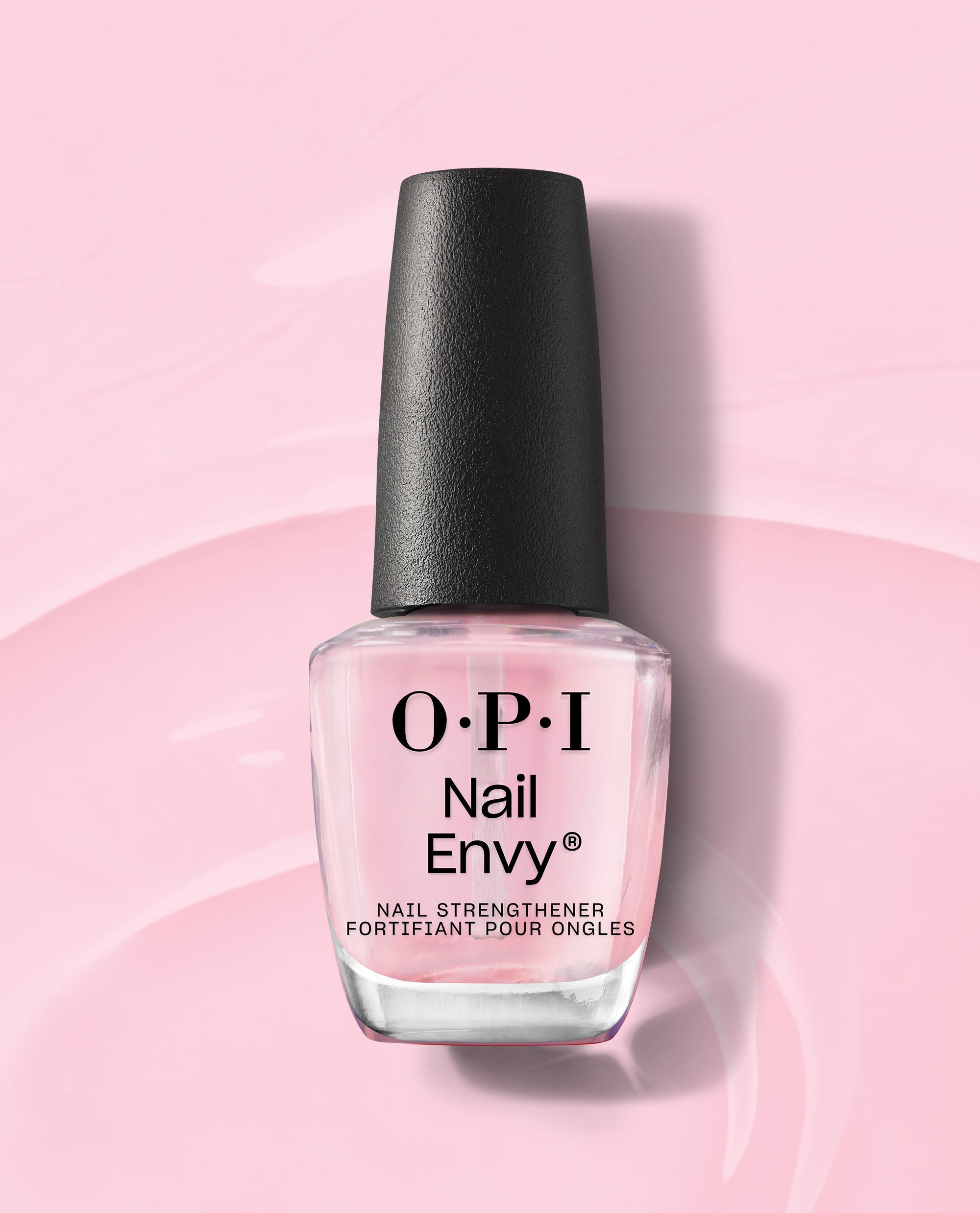 OPI Nail Envy Pink To Envy Nail Strengthener bottle standing upright, showcasing its sheer pink treatment formula and black cap on a glossy pastel pink background, perfect addition to an OPI nail polish gift set.