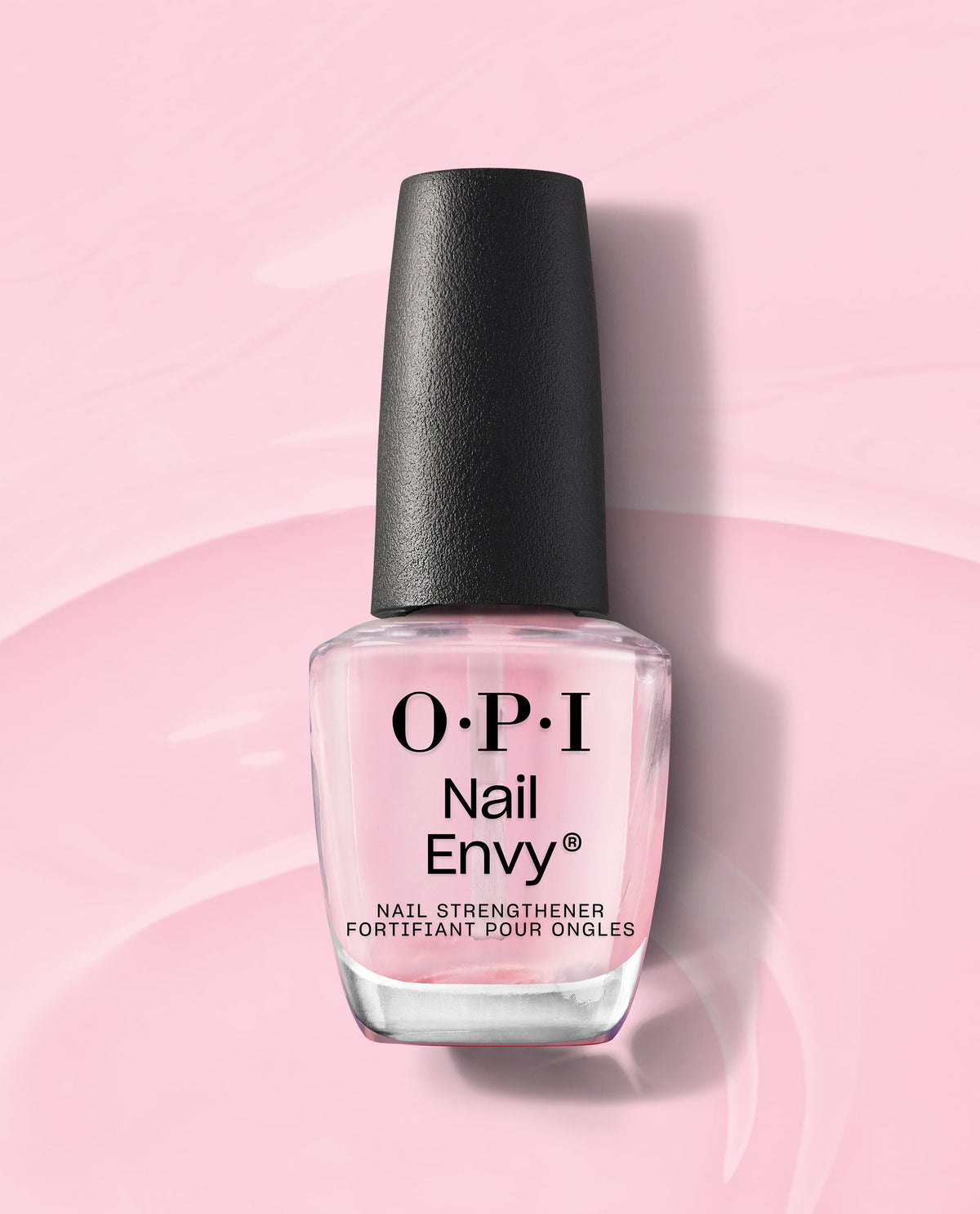 OPI Nail Envy Pink To Envy Nail Strengthener bottle standing upright, showcasing its sheer pink treatment formula and black cap on a glossy pastel pink background, perfect addition to an OPI nail polish gift set.