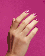 Hand displays glossy metallic pink nails with OPI Nail Envy Powerful Pink Nail Strengthener, a trending nail treatment, against a vivid magenta background.