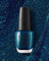 OPI nail polish bottle of Nessie Plays Hide & Sea-k nail lacquer standing upright, showcasing a deep teal-blue glitter shade against a matching sparkling blue background.
