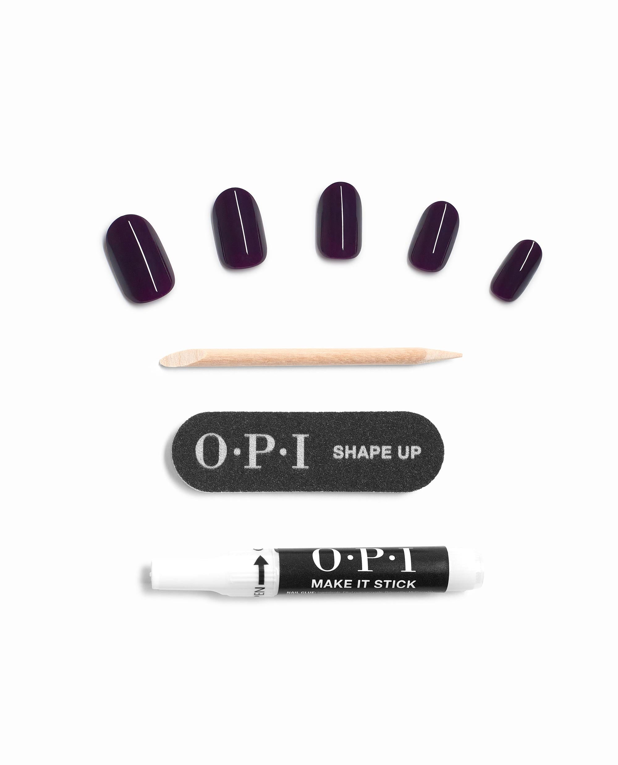 OPI On Point O Suzi Mio press-on nails display glossy deep plum fall nail colors with a wooden cuticle stick, Shape Up nail file, and Make It Stick nail glue on a white background.