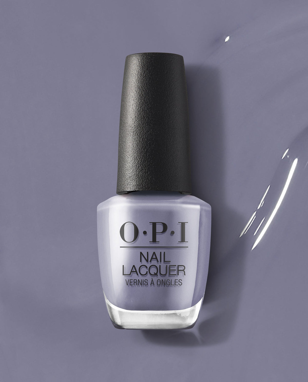 OPI ❤️ DTLA OPI nail polish bottle standing upright, showcasing a creamy muted lavender-gray nail lacquer shade against a matching glossy painted background, highlighting the modern, city-inspired color for manicures and pedicures.