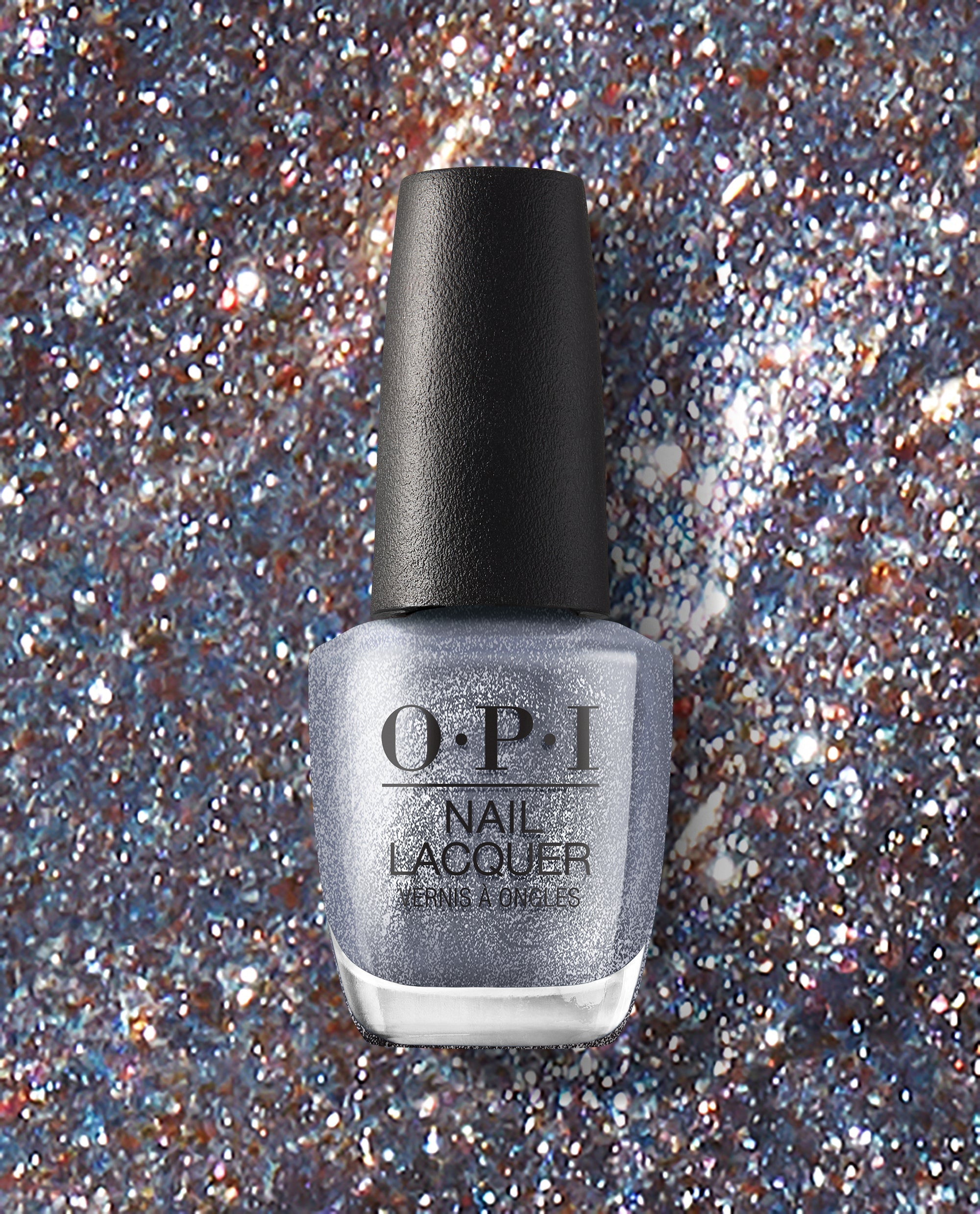 OPI Nails the Runway OPI nail polish bottle standing upright, showcasing silver glitter nail lacquer against a sparkling multicolor glitter background, emphasizing the shimmery, high-shine finish of this OPI nail lacquer shade.