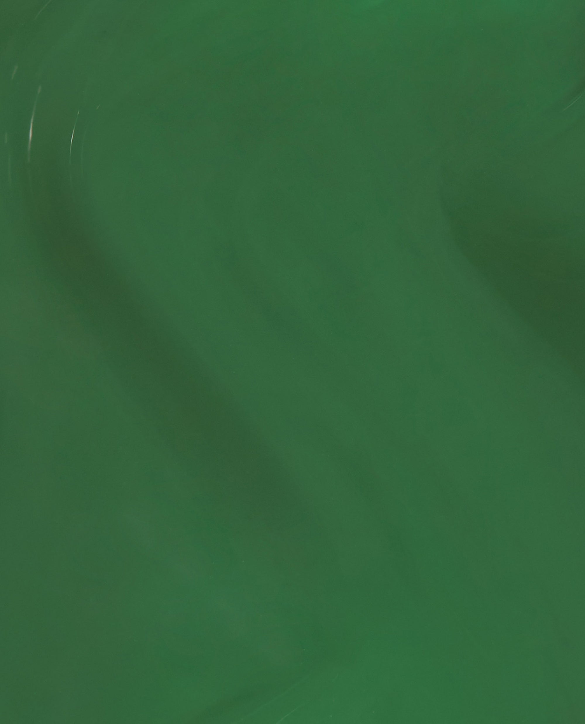 OPI’m a Supermodel Infinite Shine green nail polish swatch showcasing a rich, glossy emerald cream flowing smoothly across a close-up surface, highlighting even coverage and long-wear shine—perfect for spring nail colors from OPI.