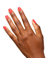 Hand models glossy coral-red OPI Infinite Shine nail polish in Pack a Cherry-on Bag on short rounded nails against a clean white background, showcasing a trending manicure shade.