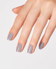Hand with neatly manicured nails painted in Peace of Mined, a soft gray OPI nail polish nail lacquer, shown against a clean white background to highlight the smooth, glossy finish and modern neutral shade.