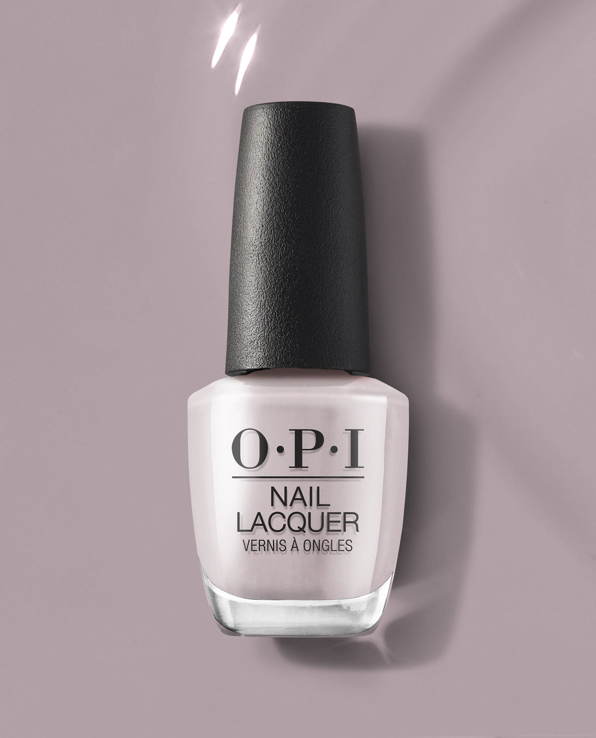 OPI nail polish bottle in Peace of Mined, a soft dusty mauve nail lacquer, standing upright on a matching mauve background with subtle shine, showcasing the classic OPI logo and sleek black cap for a modern, salon-quality look.