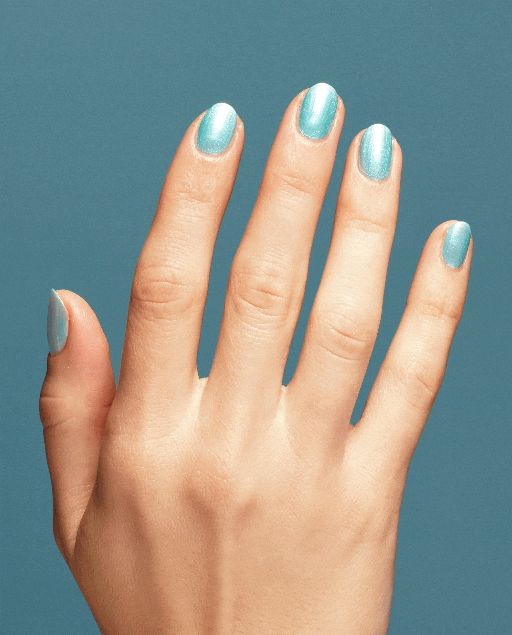 Hand with neatly manicured nails showcases Pisces the Future OPI nail polish, a shimmering aqua blue nail lacquer, against a matching teal background for a glossy, modern look.