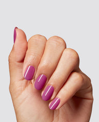 Hand modeling OPI Pompeii Me in Nails at-home gel nail polish, a glossy magenta-purple manicure with oval nails, ideal for vibrant fall nail colors.