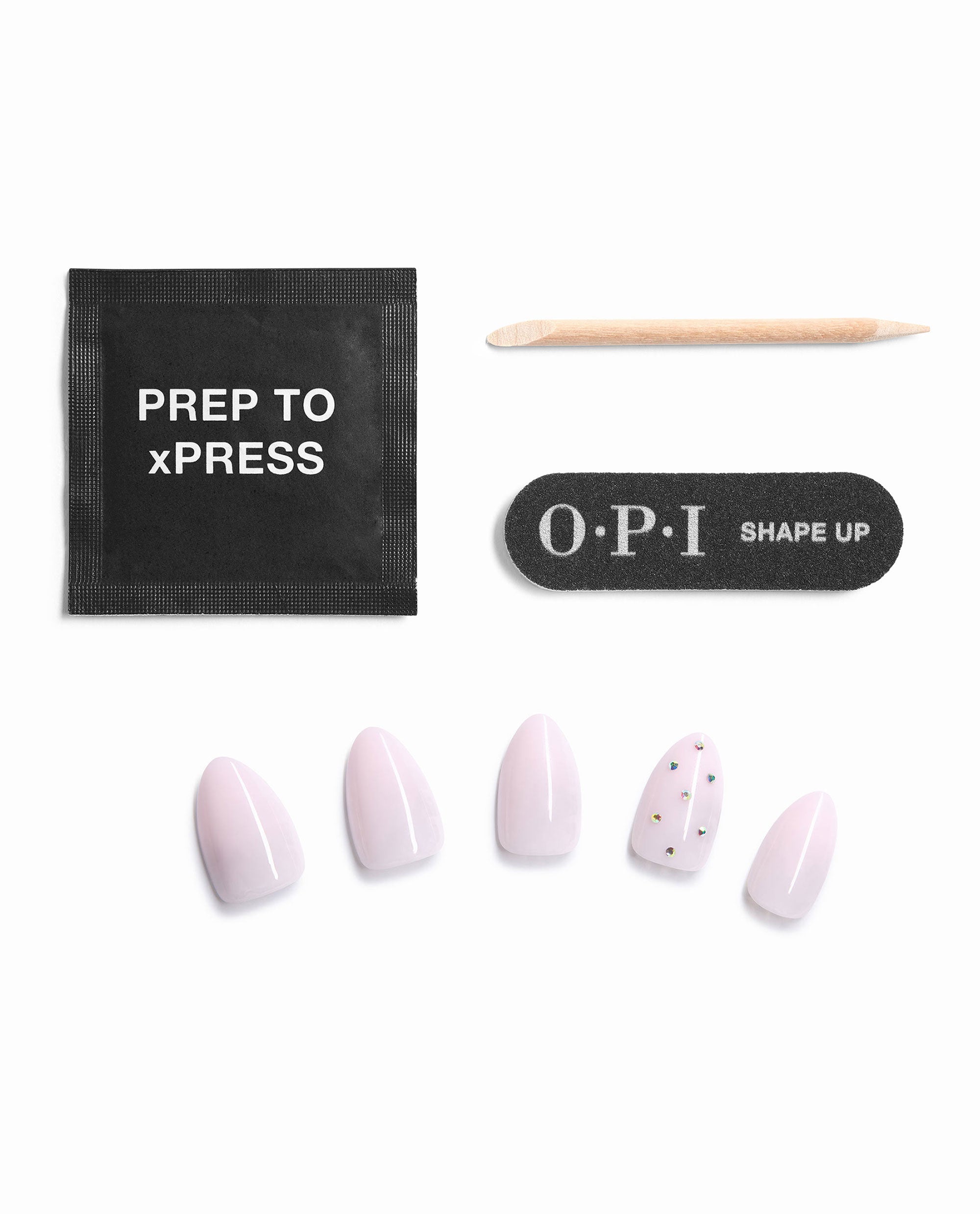 OPI Princess Treatment Sticking Point press-on nail kit displays pale pink artificial nails with rhinestone accents, prep pad, wooden stick, and Shape Up nail file on a white background, a soft choice for fall nail colors.