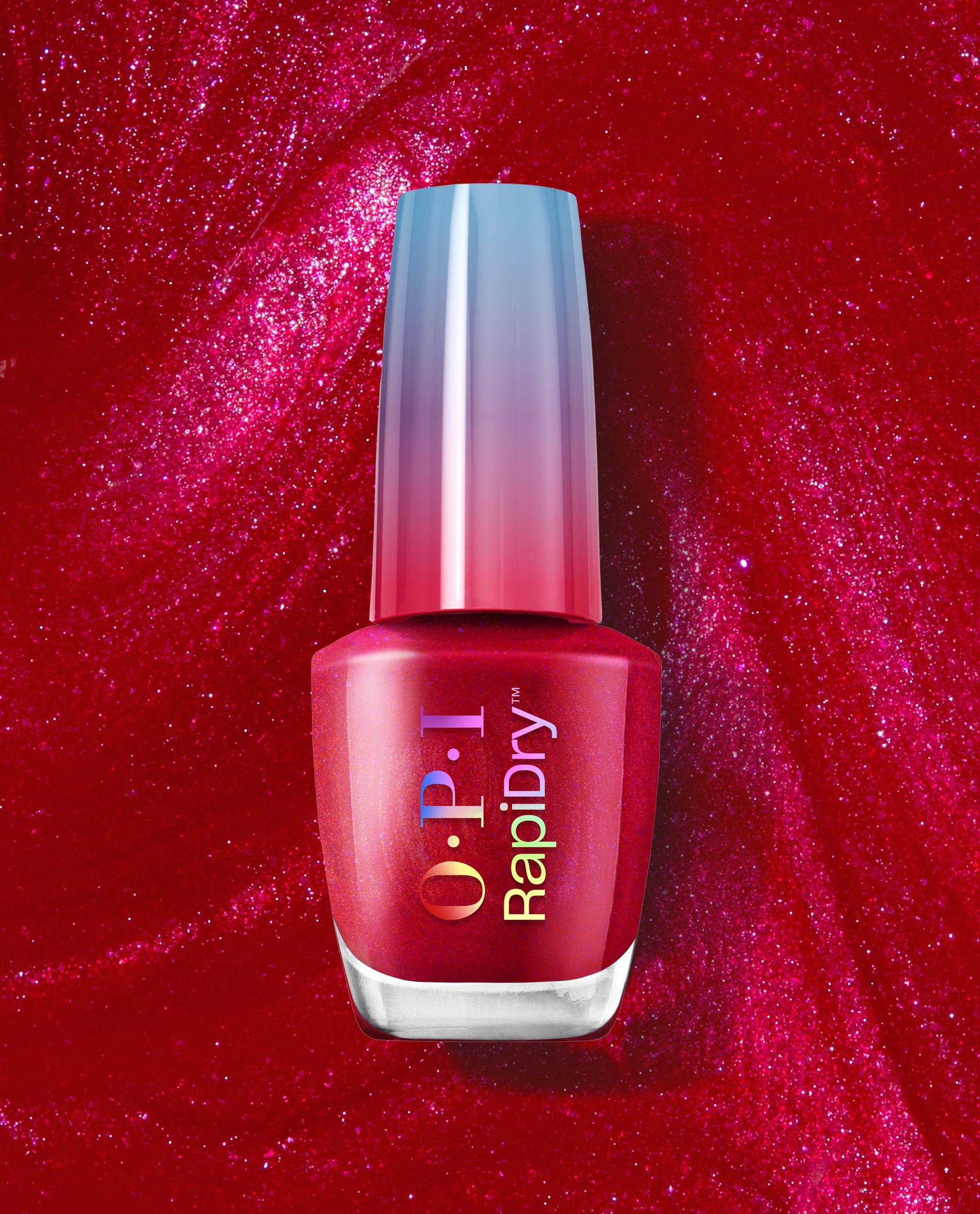 OPI Ring the Alarm RapiDry red shimmer nail polish bottle stands against a sparkling crimson polish background, showcasing a quick-dry shade for bold fall nail colors.