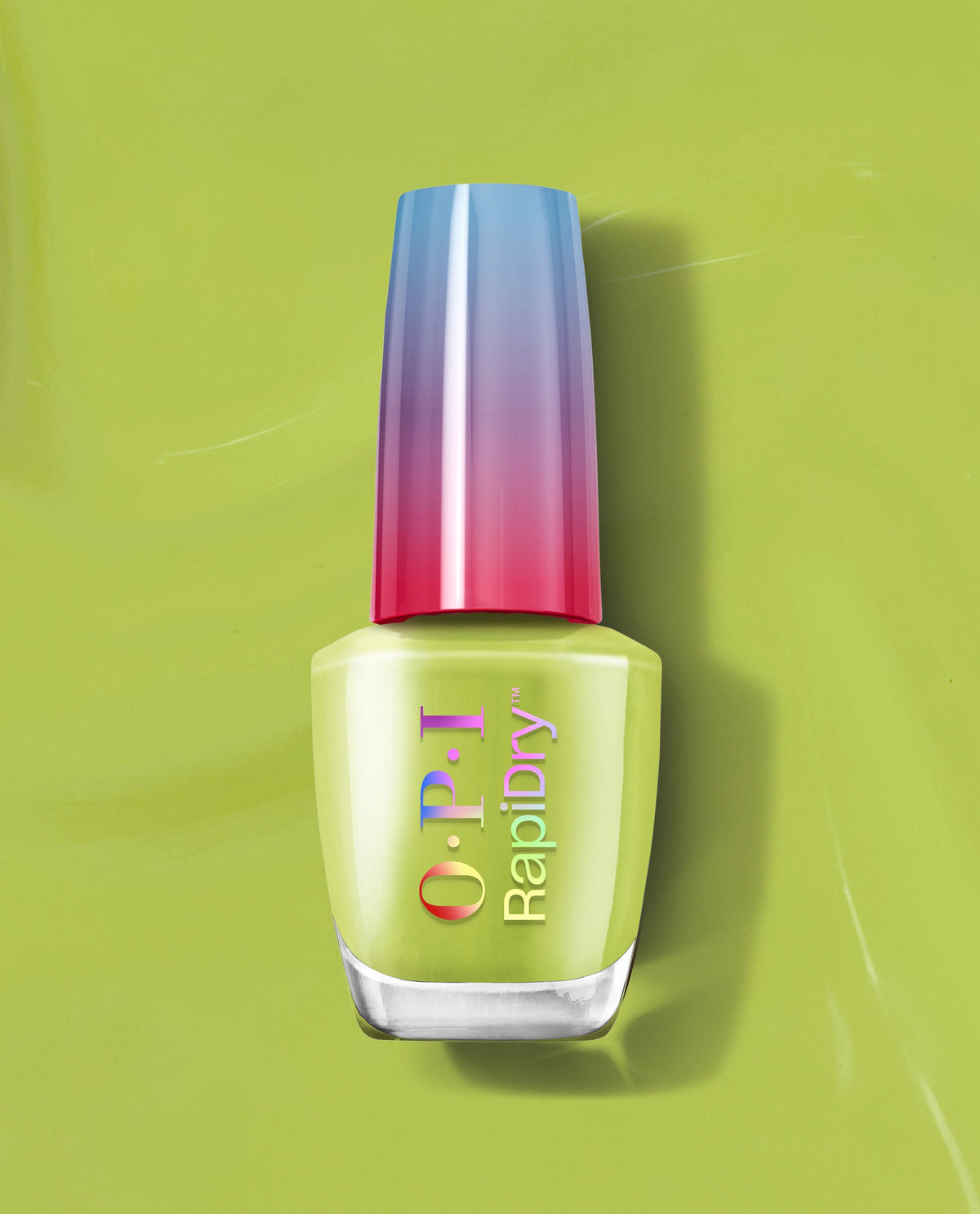 OPI RapiDry™ Screen-Grab Green bottle stands upright, showing a glossy chartreuse green nail polish with a gradient blue-to-pink cap, set on a matching lime backdrop—fast-dry shade ideal for spring nail colors from OPI.
