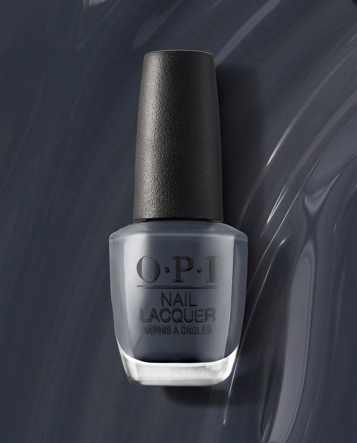 OPI nail polish bottle of Rub-a-Pub-Pub nail lacquer standing upright, showing a deep smoky gray shade with a black textured cap, set against a glossy swirled gray background highlighting the cool-toned color.