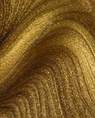SaTURN Me On OPI nail polish nail lacquer swirling in close-up, showing dense metallic gold shimmer with fine glitter particles creating luminous, molten gold waves across the polish surface.