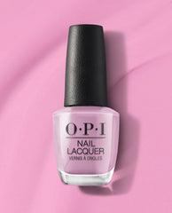 Seven Wonders of OPI nail lacquer bottle filled with soft pastel pink OPI nail polish, standing upright with a black textured cap on a matching pink background, showcasing the classic OPI branding for a salon-quality manicure look.