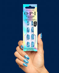 Hand holds OPI Snap, Crackle, Gloss Sticking Point press-on nails, a blue metallic crackle manicure option for fall nail colors, against a navy background.