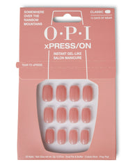 OPI Somewhere Over the Rainbow Mountains xPRESS/ON Iconic Shades (Short) press-on nails arranged in a clear tray inside peach pink packaging, showcasing soft rosy nude fake nails as an easy OPI nail polish gift set for instant gel-like salon manicure