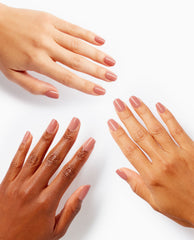 Three sets of hands with short, glossy nude-pink nails model the Somewhere Over the Rainbow Mountains xPRESS/ON Iconic Shades, showcasing the OPI nail polish gift set on diverse skin tones against a clean white background.