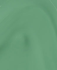 OPI $elf Made nail lacquer swatch gliding in a glossy, creamy pastel green, showing smooth brushstroke texture—an on-trend green nail polish perfect for spring nail colors.
