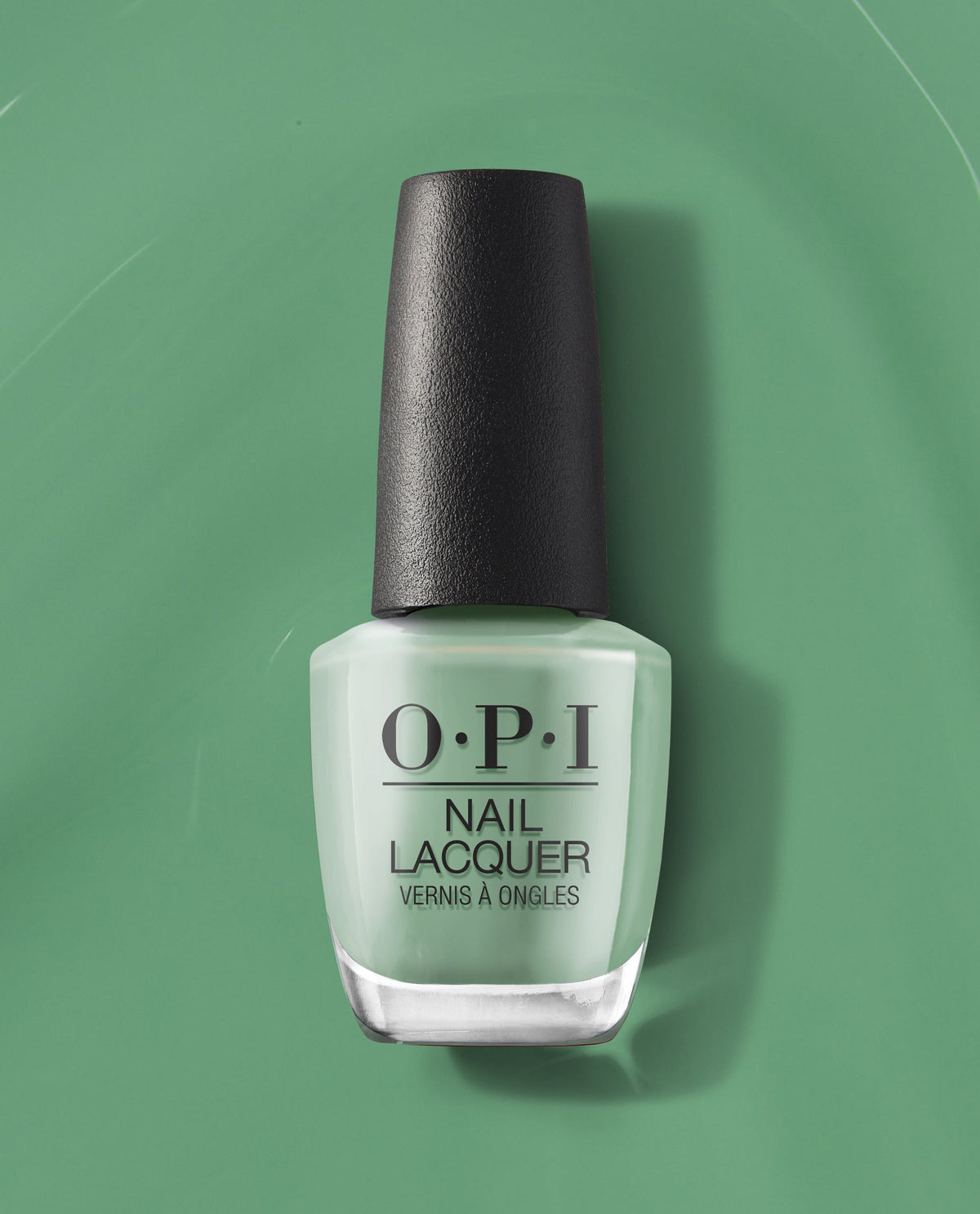 OPI $elf Made Nail Lacquer bottle standing upright, showcasing a pastel mint green shade of green nail polish with a black textured cap, set against a matching green backdrop—a fresh, modern pick for spring nail colors from OPI.