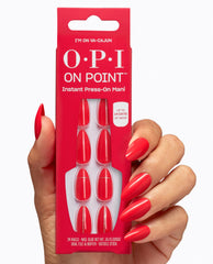 Hand with glossy red almond nails holds OPI On Point I’m on Va-Cajun instant press-on mani pack, showing matching red nails with subtle gold line accents.