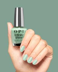 OPI Infinite Shine Teals Familiar green nail polish glossing manicured nails as a hand holds the bottle, a shimmery pastel teal perfect for spring nail colors; 15 mL gel-like lacquer by OPI against a matching mint backdrop.