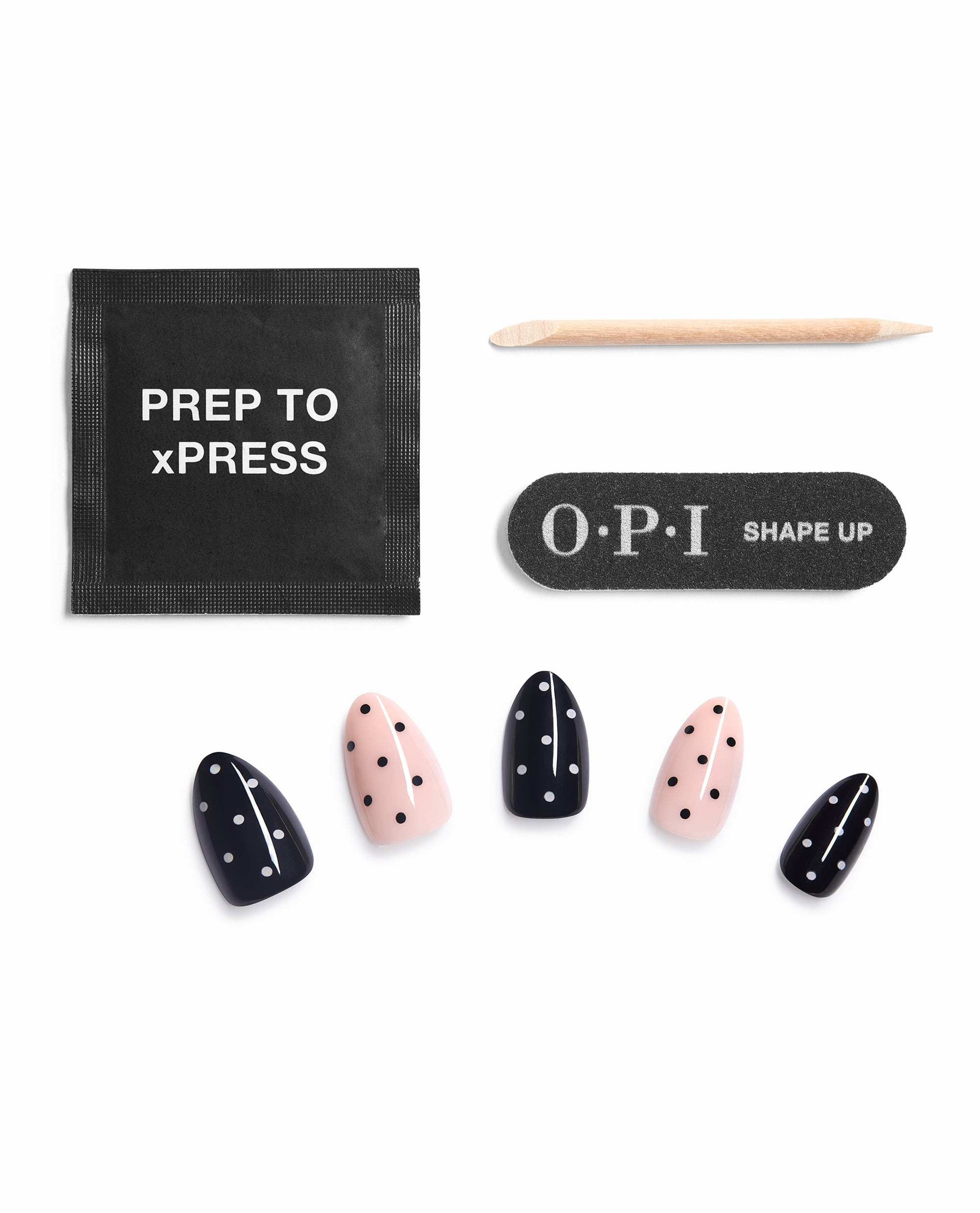 OPI Spot On Sticking Point press-on nail kit displays black and pale pink polka dot fall nail colors with prep pad, wooden cuticle stick, and OPI Shape Up nail file on a white background.