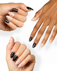 Spot On Sticking Point manicure shows almond nails in glossy black and soft blush pink with contrasting polka dots, modeled on diverse hands against a white background for OPI fall nail colors inspiration.