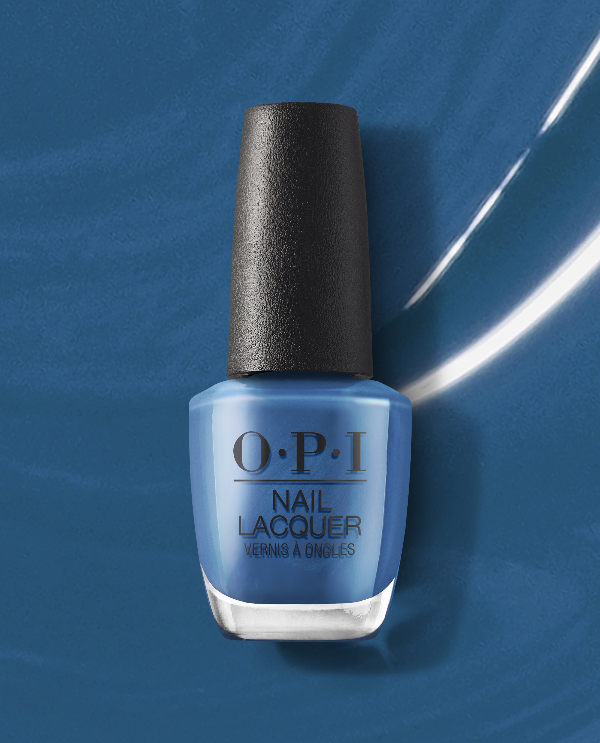 OPI nail polish bottle of Suzi Takes a Sound Bath nail lacquer standing upright, showcasing its rich medium blue shade against a glossy blue painted background, highlighting the salon-quality, long-wear manicure finish.