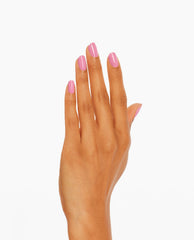 Hand with neatly manicured nails shows Suzi Will Quechua Later! OPI nail polish, a glossy medium pink nail lacquer shade, against a clean white background for a modern, salon-quality look.