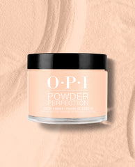 OPI Powder Perfection Suzi Take a Vow dipping powder jar with black lid, showing a soft peach nude shade against a matching powder-textured background for fall nail colors.