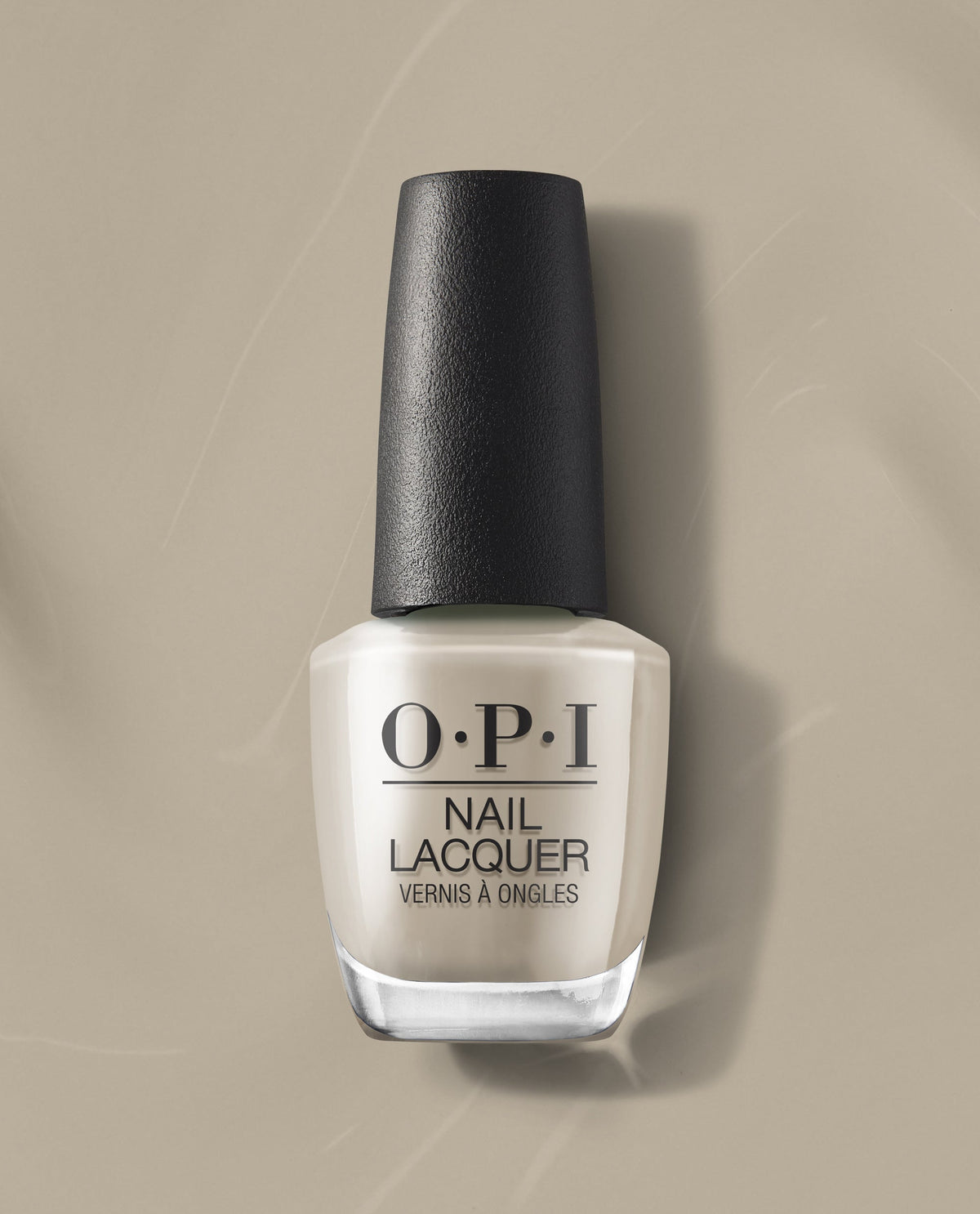 OPI nail polish bottle of Suzi’s Pager nail lacquer in a soft beige cream shade standing upright on a matching neutral beige background, highlighting the glossy finish and black textured cap for a modern, minimalist product look.