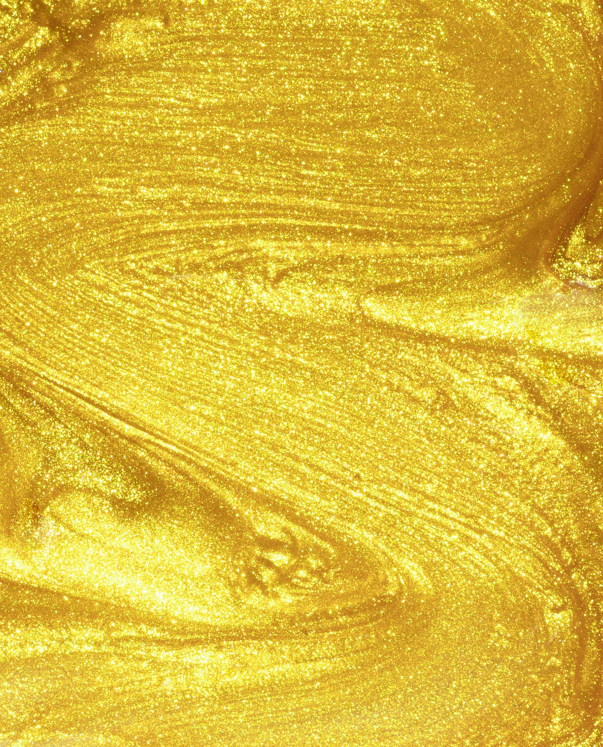 The Leo-nly One OPI nail polish swatch showing metallic, shimmery yellow-gold nail lacquer flowing in smooth, radiant streaks, highlighting its glittery, high-shine finish against a close-up studio background.