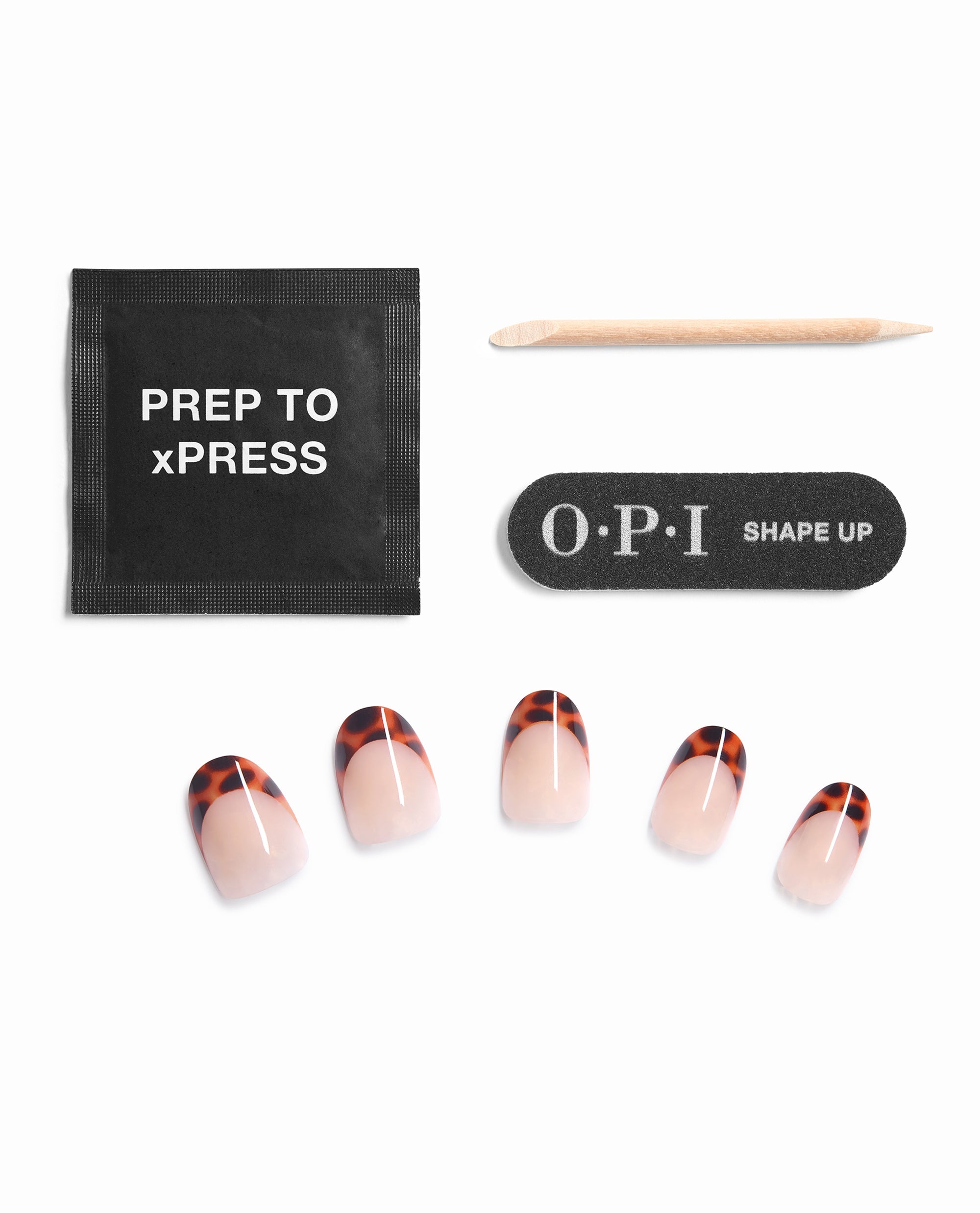 OPI Tortie Tips Sticking Point press-on nails showcase fall nail colors with tortoiseshell French tips, arranged with a prep pad, wooden cuticle stick, and OPI Shape Up nail file on a white background.