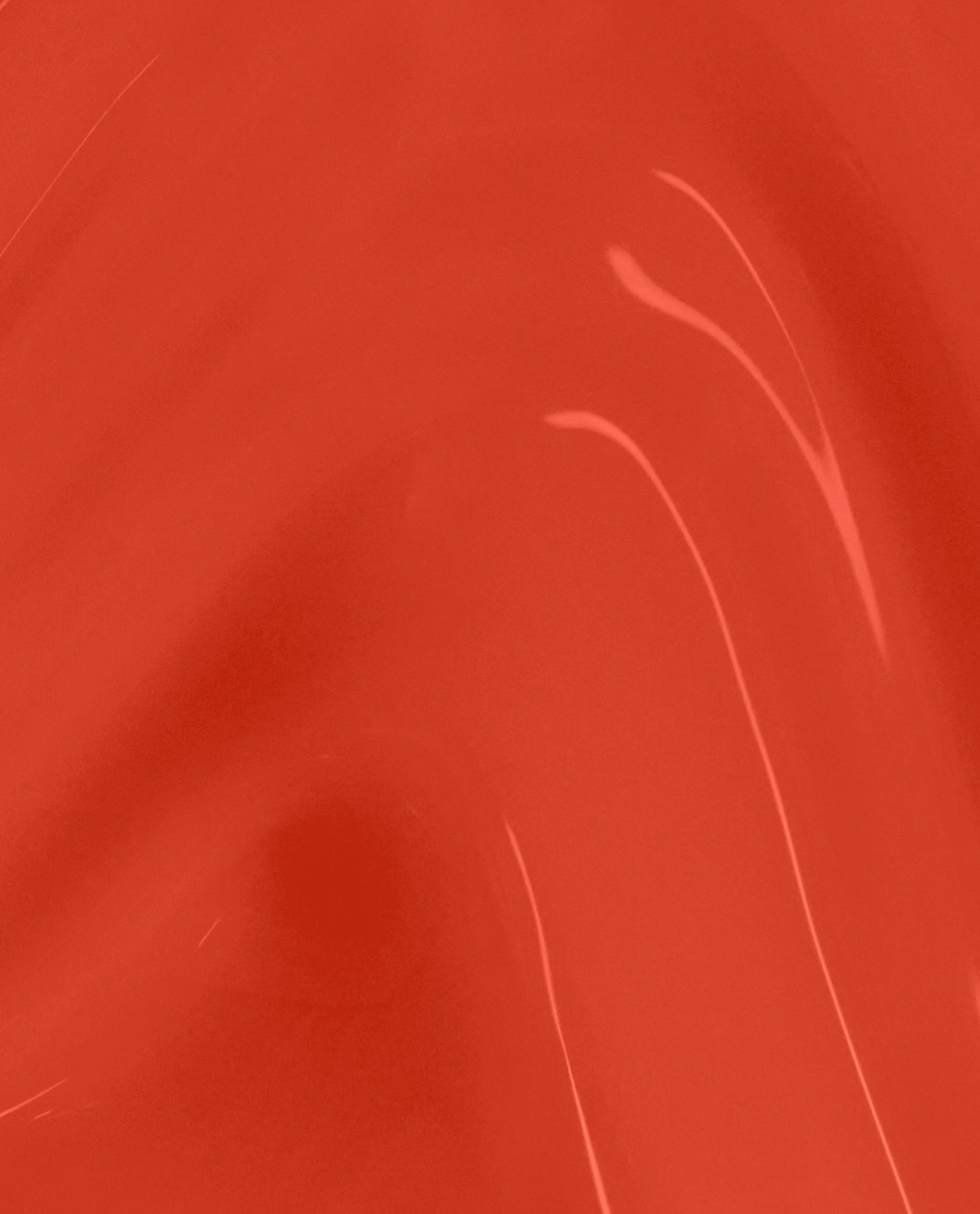 Totally Red-ical nail lacquer swatch shows a glossy, vivid red-orange shade with subtle brush streaks, a bold OPI option for fall nail colors.