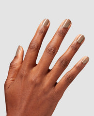Hand displays OPI Infinite Shine Track Suited Cutie, a glossy taupe-gray shimmer fall nail color, on short rounded nails against a light gray studio background.