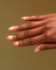 Hand with medium-length almond nails painted in #Virgoals, a shimmering bronze-gold OPI nail polish nail lacquer, fanned gracefully against a warm golden background to showcase the metallic, high-shine finish for US beauty shoppers.