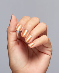 Hand posed against a light gray background showing short, neatly manicured nails painted with #Virgoals, a shimmery golden OPI nail polish nail lacquer that creates a smooth, metallic finish for a chic everyday look.