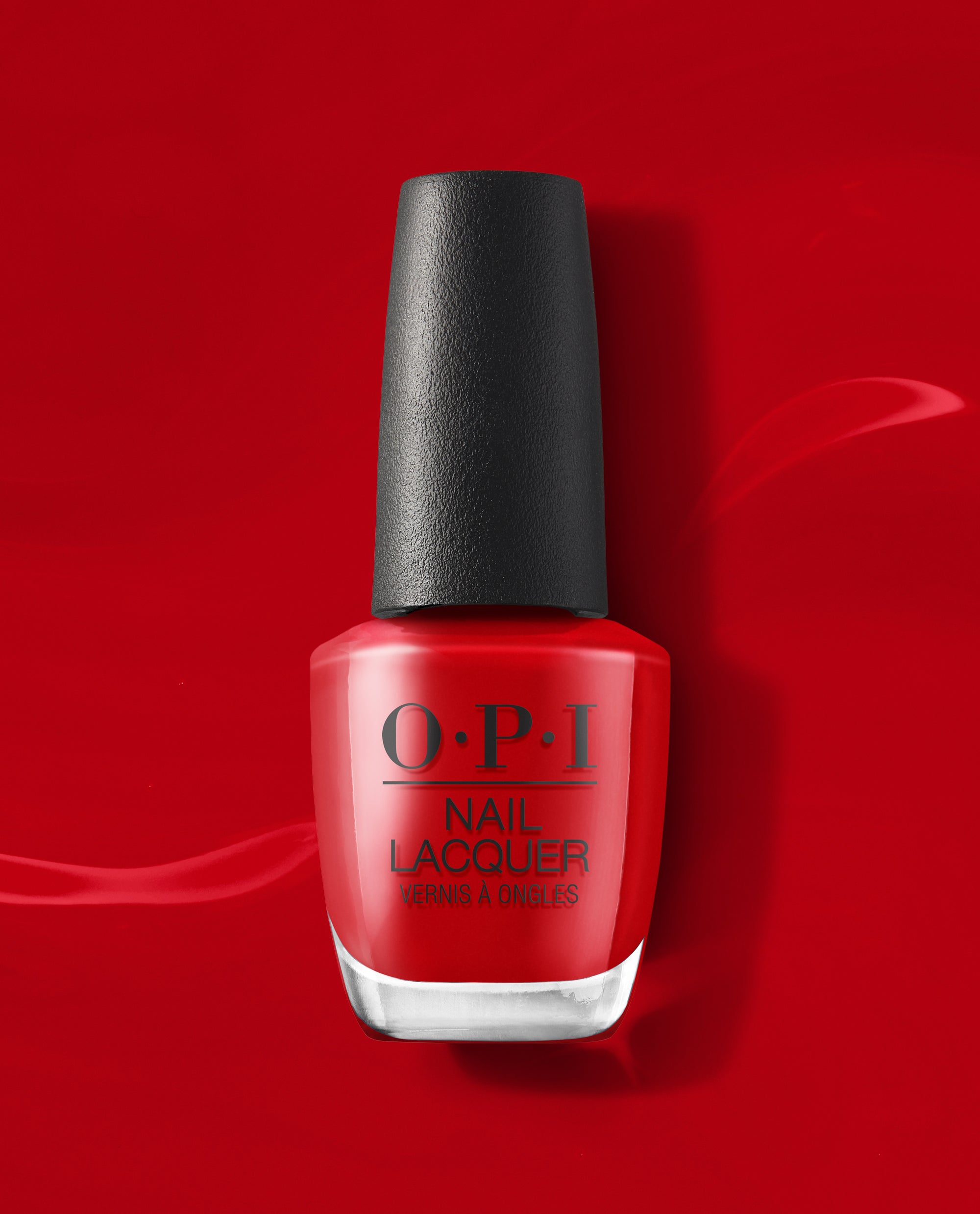 OPI Vodka & Caviar nail lacquer bottle stands upright, showing a glossy classic red polish with a black cap against a rich red background, ideal for fall nail colors.