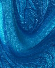 Shimmering electric blue Y2Slay nail lacquer, resembling swirling metallic waves, showcases fine glitter and high-shine finish, highlighting the vibrant color payoff and glossy texture of this OPI nail polish-inspired shade.