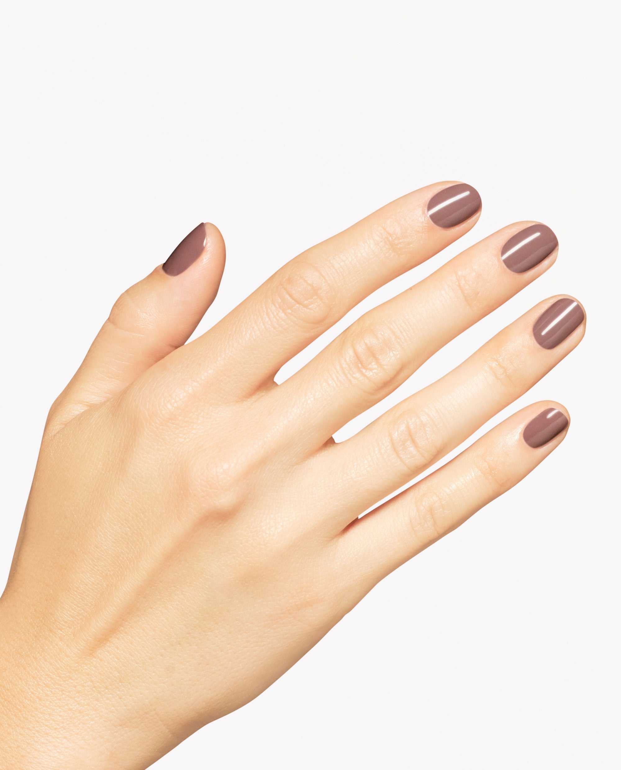 Hand modeling OPI You Don’t Know Suzi nail lacquer, a glossy taupe-brown shade on short rounded nails against a clean white background.
